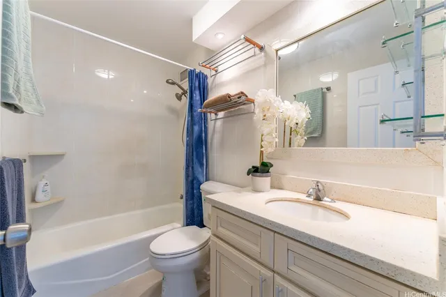 a bathroom with a sink a toilet and a large mirror