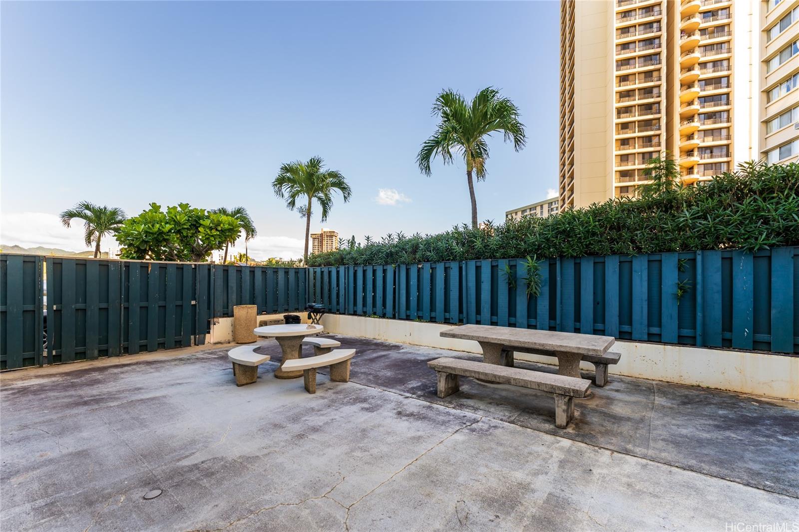 949 Ala Nanala Street, Unit 702 Honolulu, HI 96818 - Photo 21 of 23 a backyard of a house with barbeque oven and outdoor seating