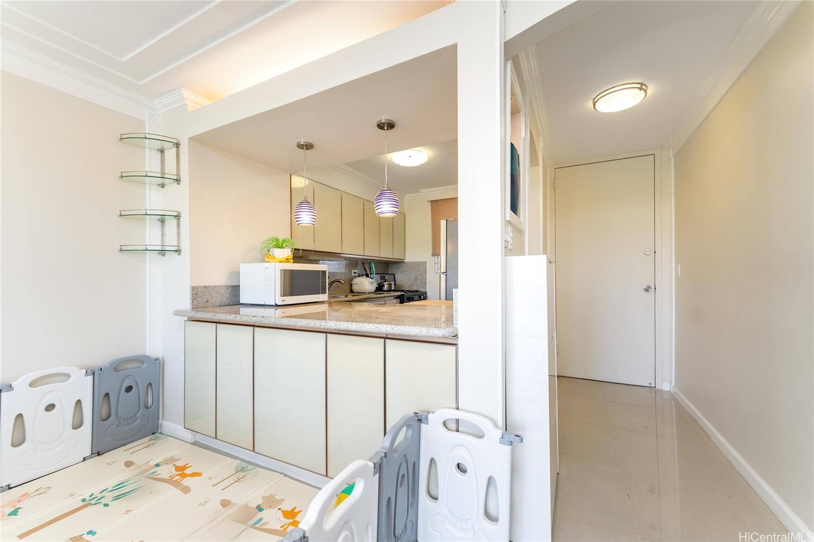 949 Ala Nanala Street, Unit 702 Honolulu, HI 96818 - Photo 3 of 23 a kitchen with a sink a refrigerator and cabinets