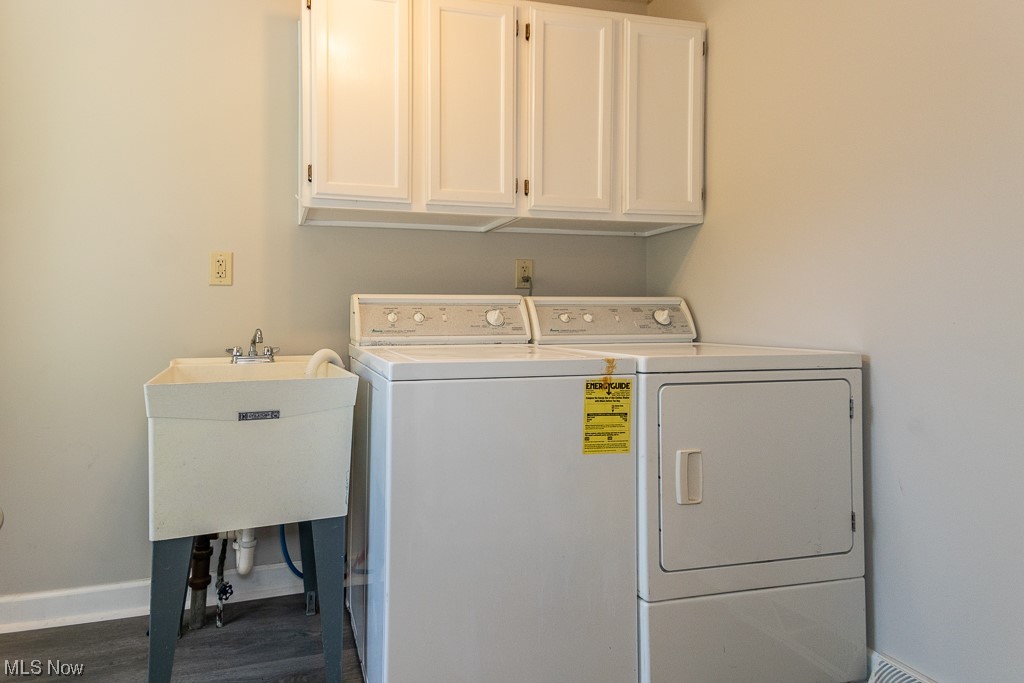 308 Wilson Mills Road Chardon, OH 44024 - Photo 4 of 21 Laundry room featuring sink, washing machine and dryer, dark wood-type flooring, and cabinets