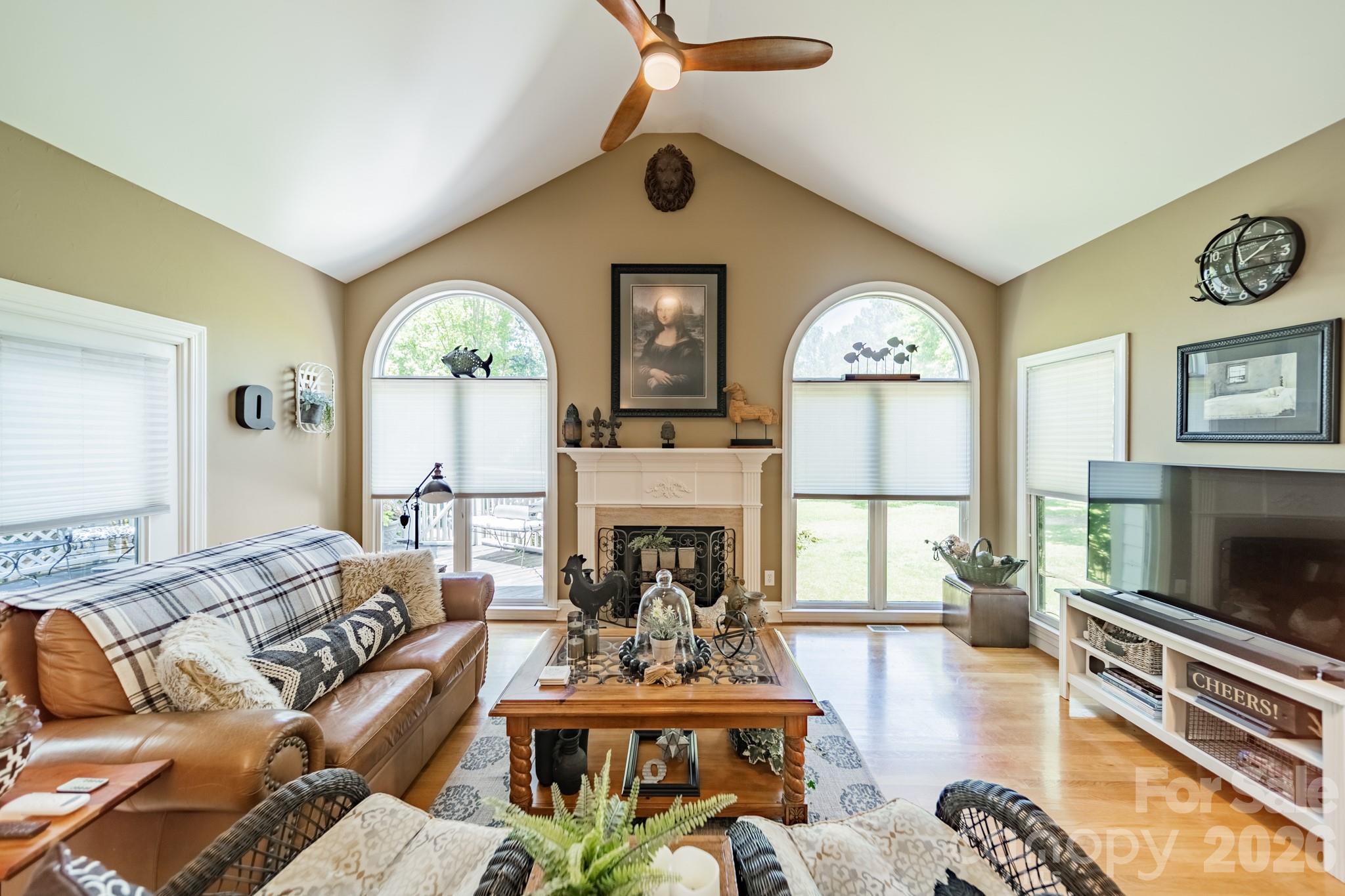 11043 Seven Coves Drive Tega Cay, SC 29708 - Photo 21 of 45 a living room with furniture a fireplace and a large window