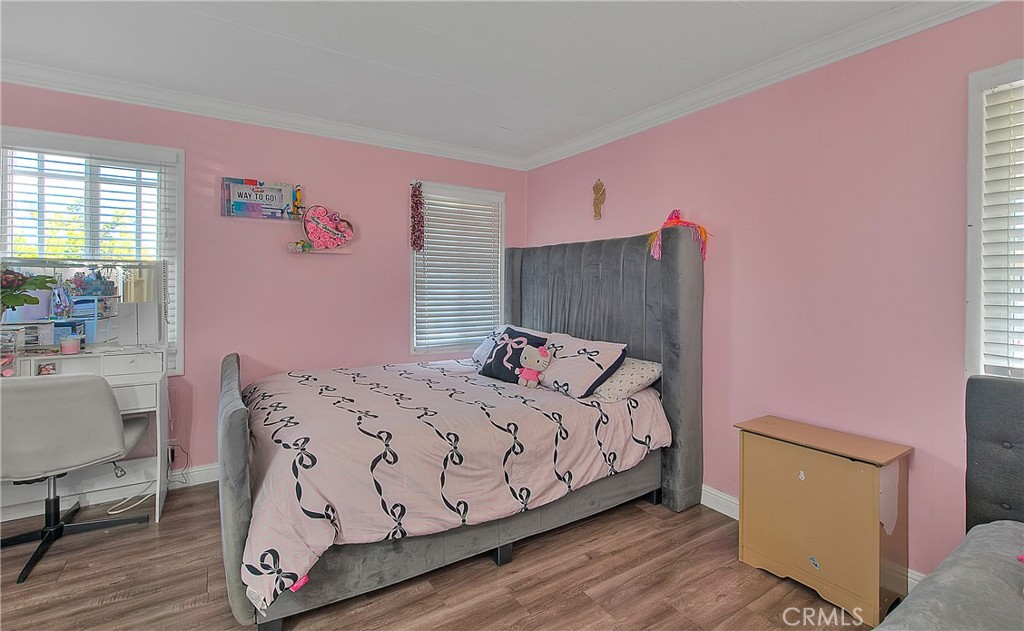 1560 Sir Damas, Unit 159 Riverside, CA 92507 - Photo 17 of 25 a bedroom with a bed and wooden floor