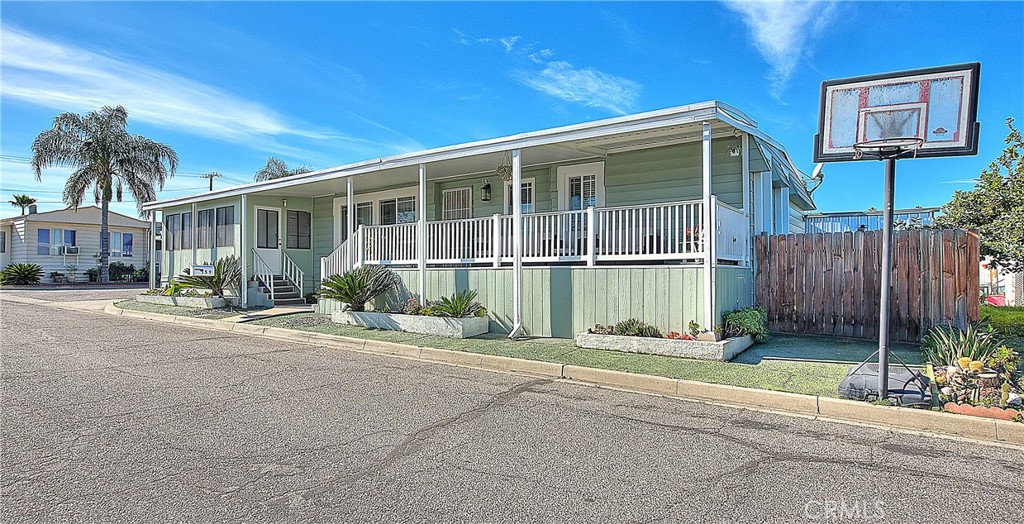 1560 Sir Damas, Unit 159 Riverside, CA 92507 - Photo 19 of 25 a front view of a house with a yard