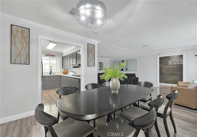 a dining room with furniture and wooden floor