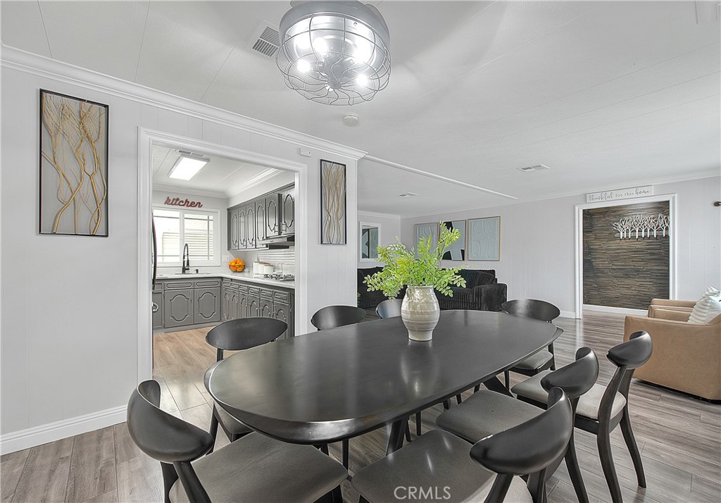 1560 Sir Damas, Unit 159 Riverside, CA 92507 - Photo 5 of 25 a dining room with furniture and wooden floor