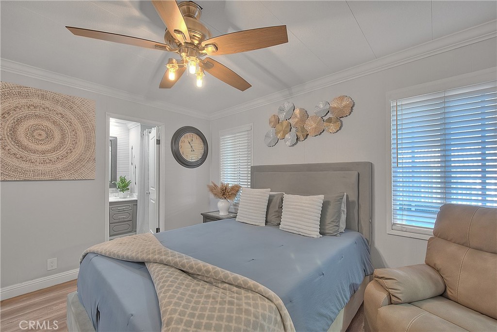 1560 Sir Damas, Unit 159 Riverside, CA 92507 - Photo 10 of 25 a bedroom with a bed and a chandelier