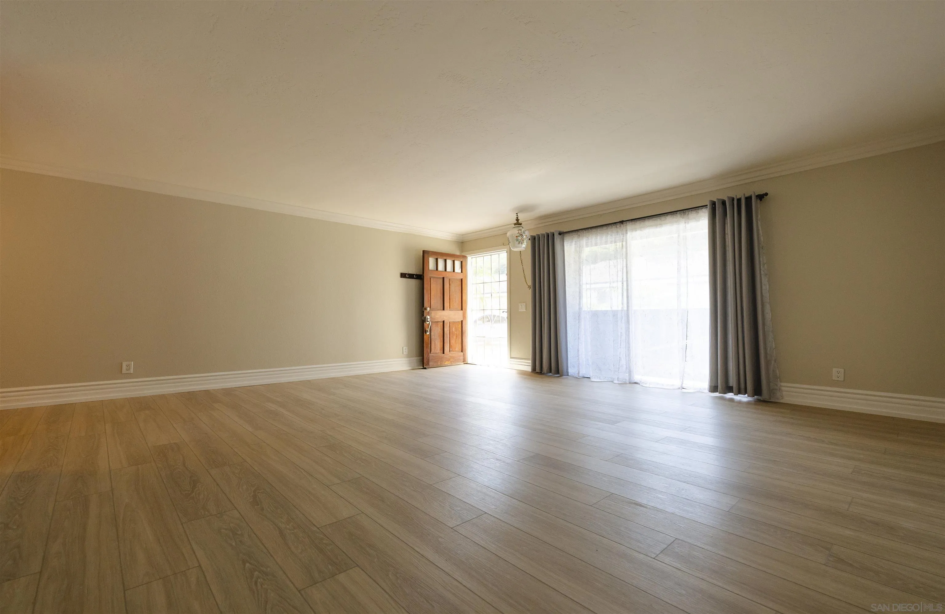 536 Telegraph Canyon Road, Unit E Chula Vista, CA 91910 - Photo 15 of 47 a view of an empty room with wooden floor and window