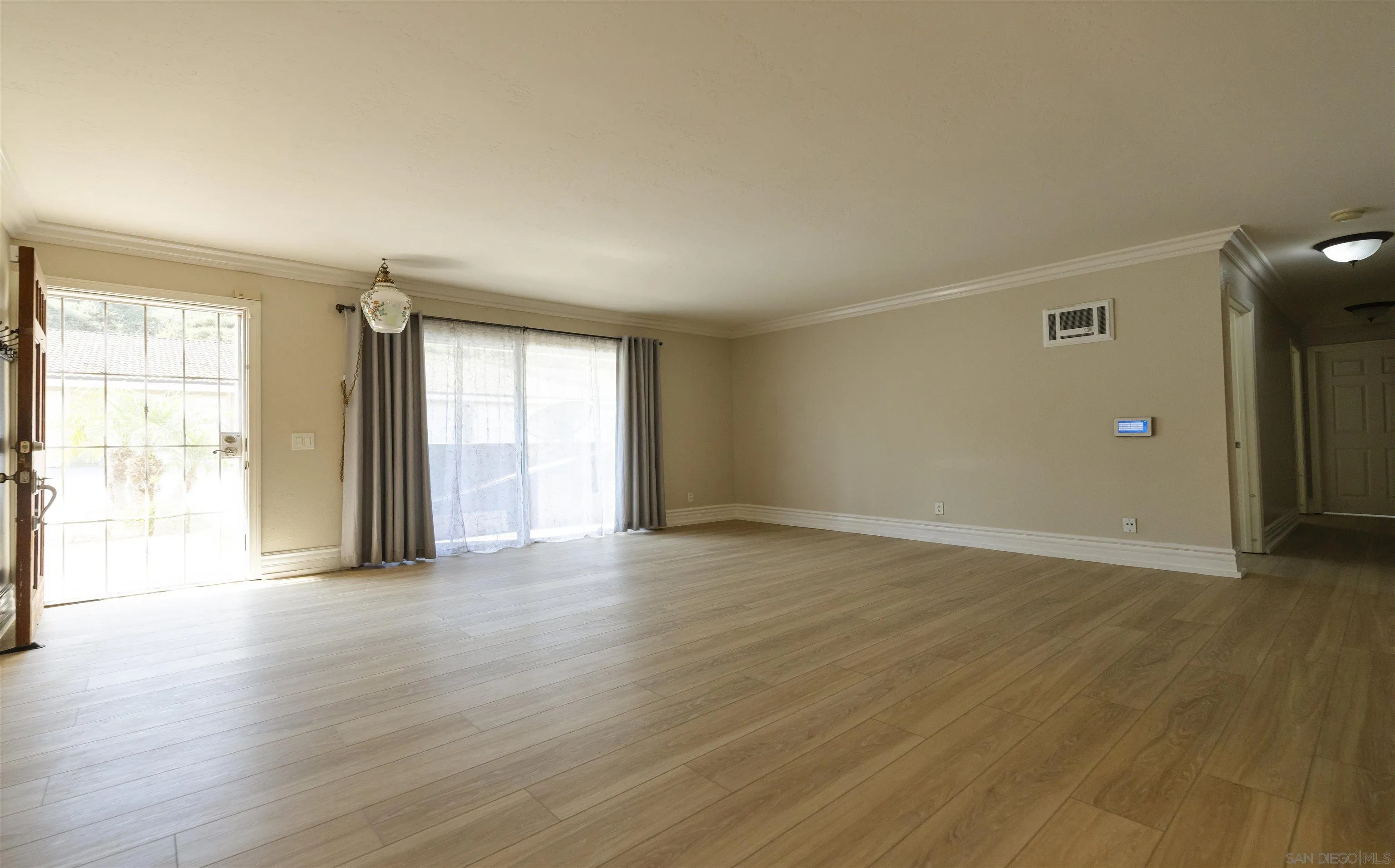 536 Telegraph Canyon Road, Unit E Chula Vista, CA 91910 - Photo 16 of 47 an empty room with wooden floor and windows