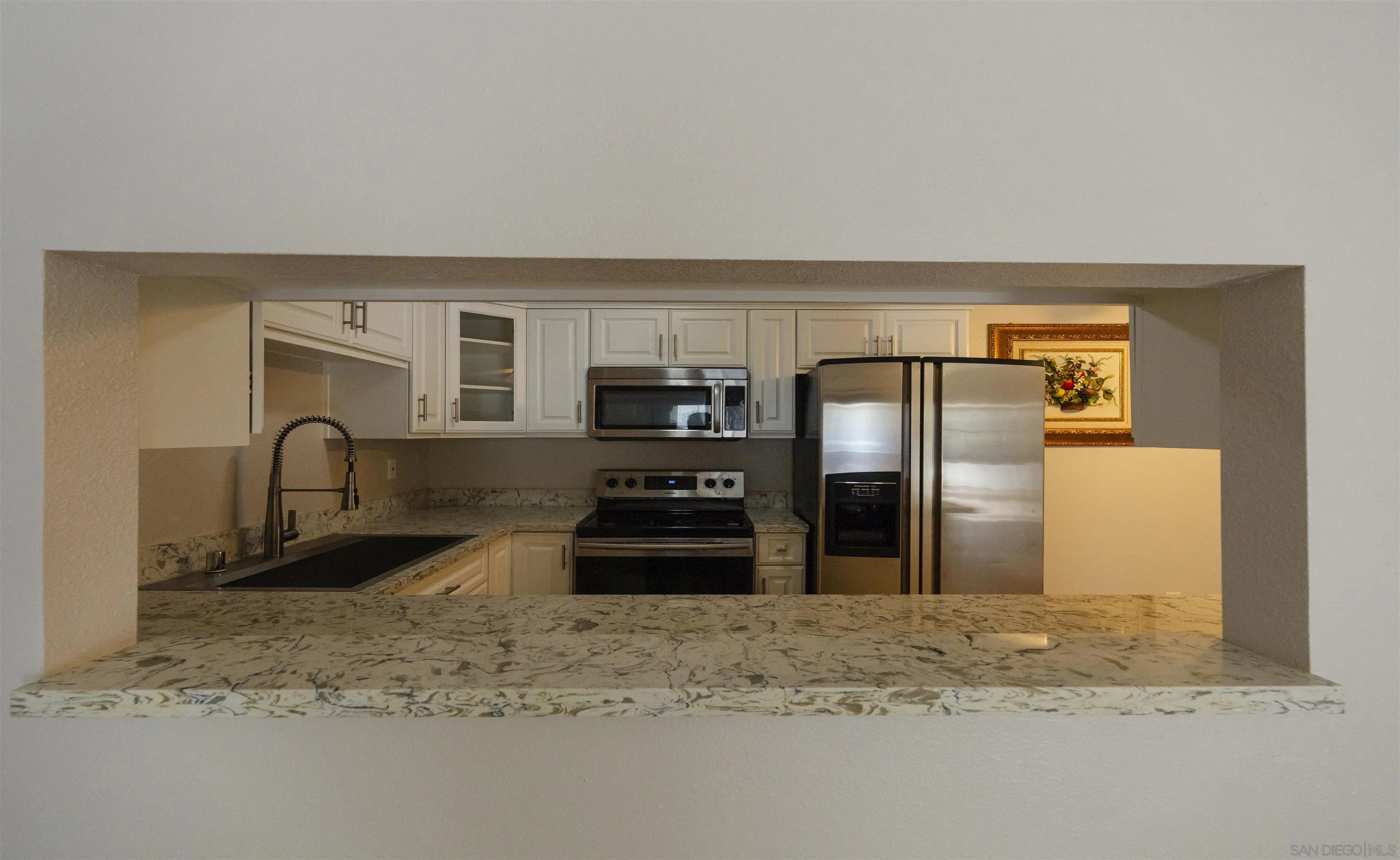 536 Telegraph Canyon Road, Unit E Chula Vista, CA 91910 - Photo 18 of 47 a kitchen with stainless steel appliances granite countertop a refrigerator and a sink