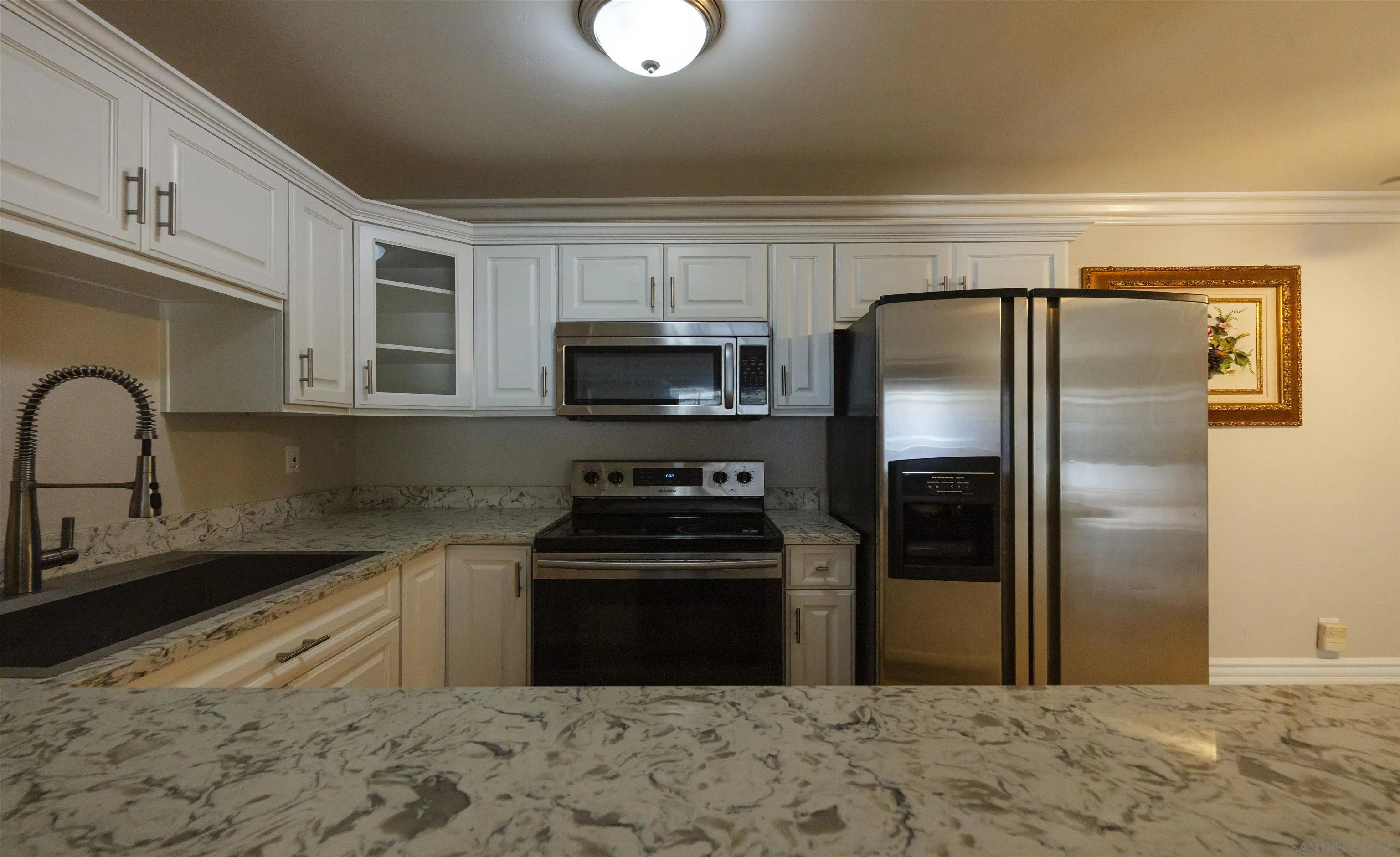 536 Telegraph Canyon Road, Unit E Chula Vista, CA 91910 - Photo 19 of 47 a kitchen with stainless steel appliances granite countertop a refrigerator a stove a sink and a microwave