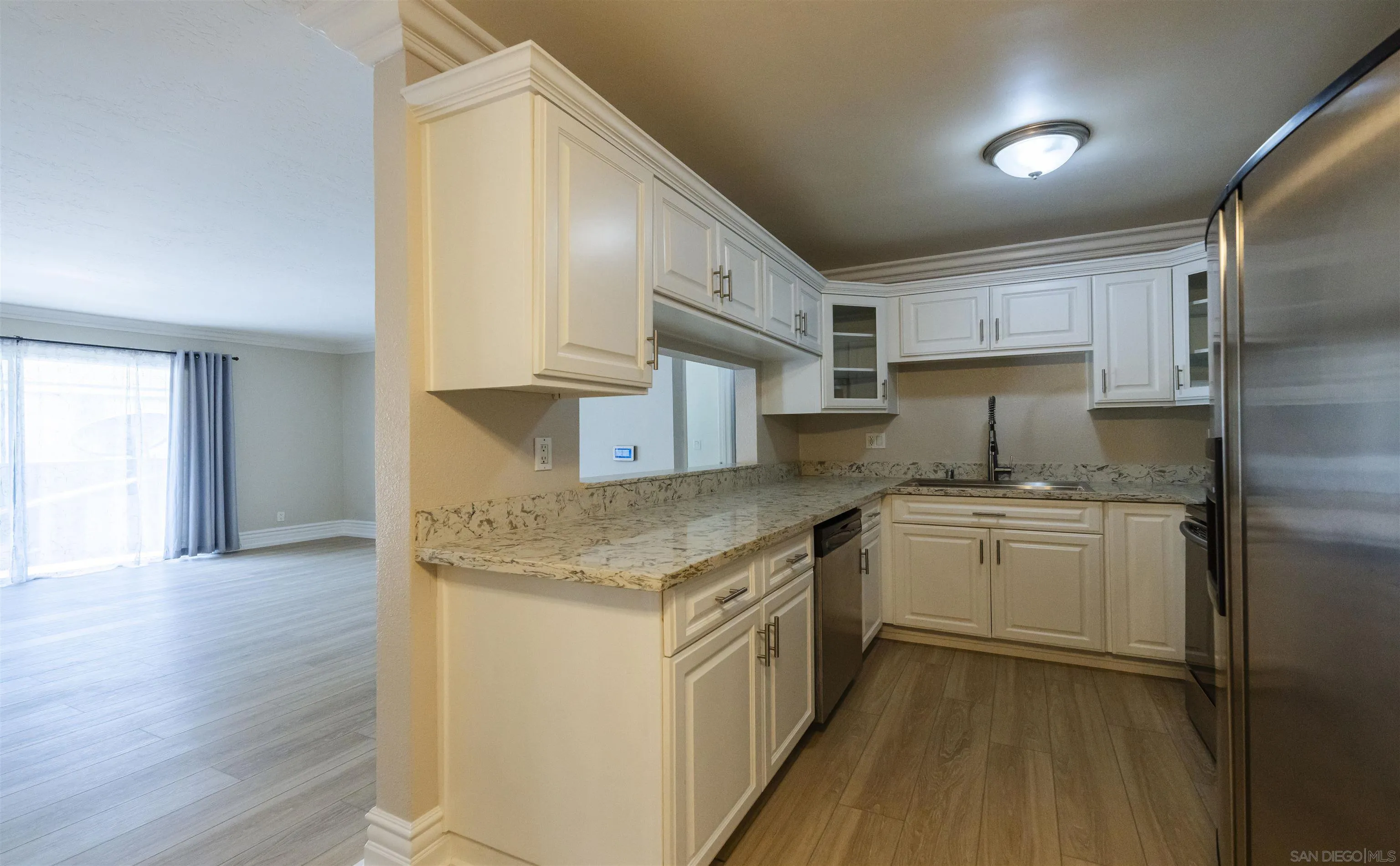 536 Telegraph Canyon Road, Unit E Chula Vista, CA 91910 - Photo 20 of 47 a kitchen with a sink cabinets stainless steel appliances and a counter top space