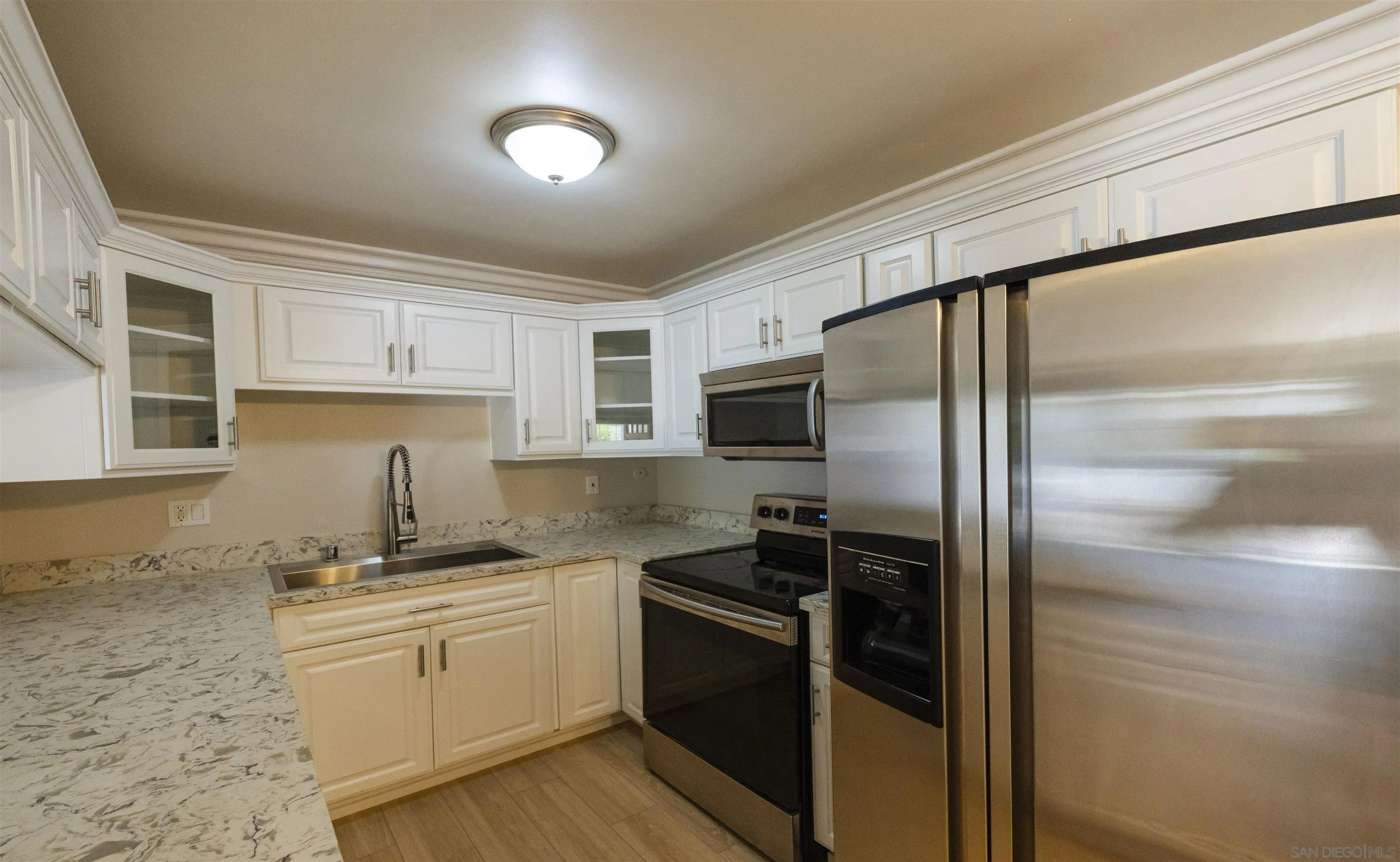 536 Telegraph Canyon Road, Unit E Chula Vista, CA 91910 - Photo 21 of 47 a kitchen with a refrigerator stove and sink