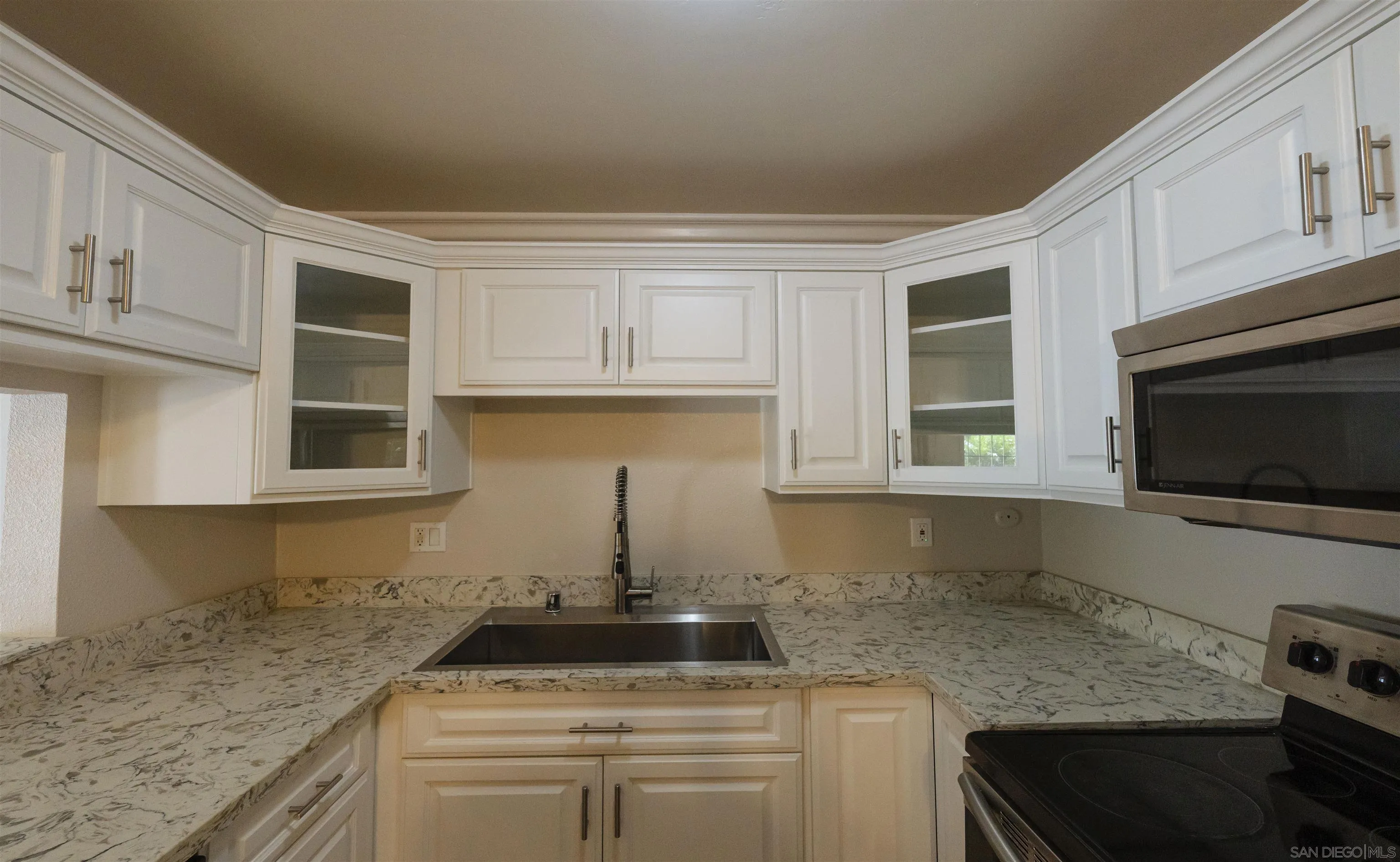 536 Telegraph Canyon Road, Unit E Chula Vista, CA 91910 - Photo 22 of 47 a kitchen with stainless steel appliances granite countertop a stove and a microwave