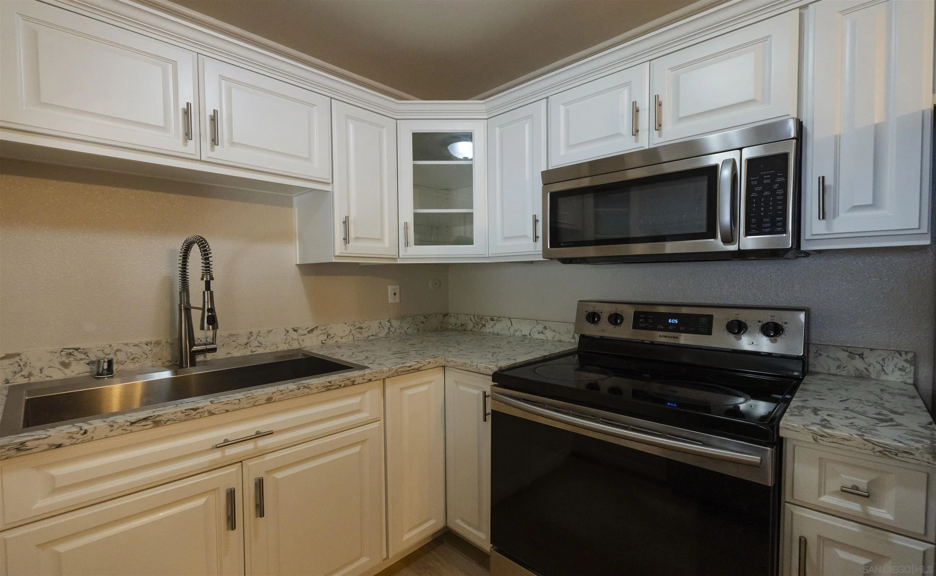 536 Telegraph Canyon Road, Unit E Chula Vista, CA 91910 - Photo 24 of 47 a kitchen with cabinets stainless steel appliances and a sink
