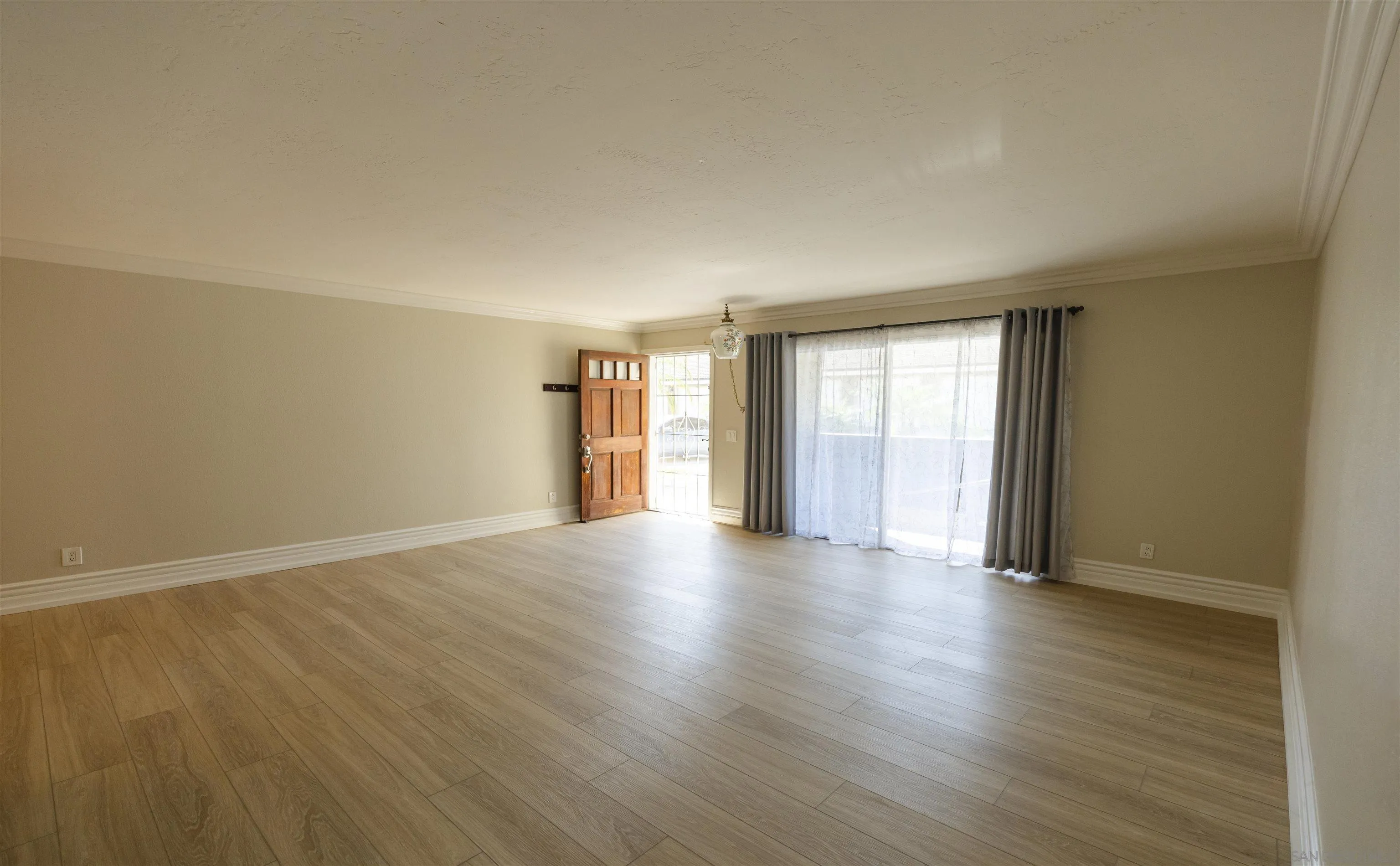 536 Telegraph Canyon Road, Unit E Chula Vista, CA 91910 - Photo 28 of 47 a view of an empty room with wooden floor and a window