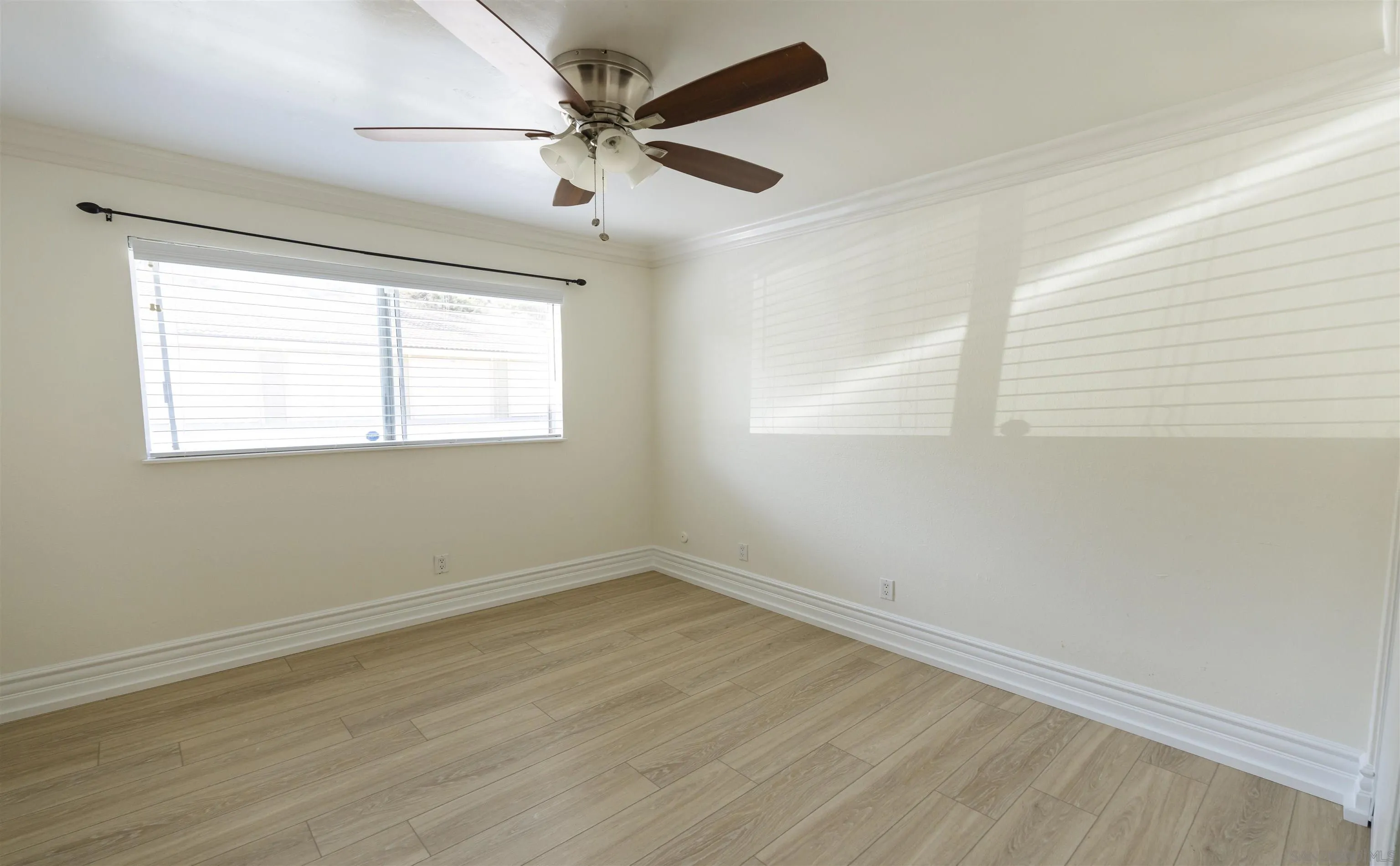 536 Telegraph Canyon Road, Unit E Chula Vista, CA 91910 - Photo 30 of 47 a view of an empty room with wooden floor and a window