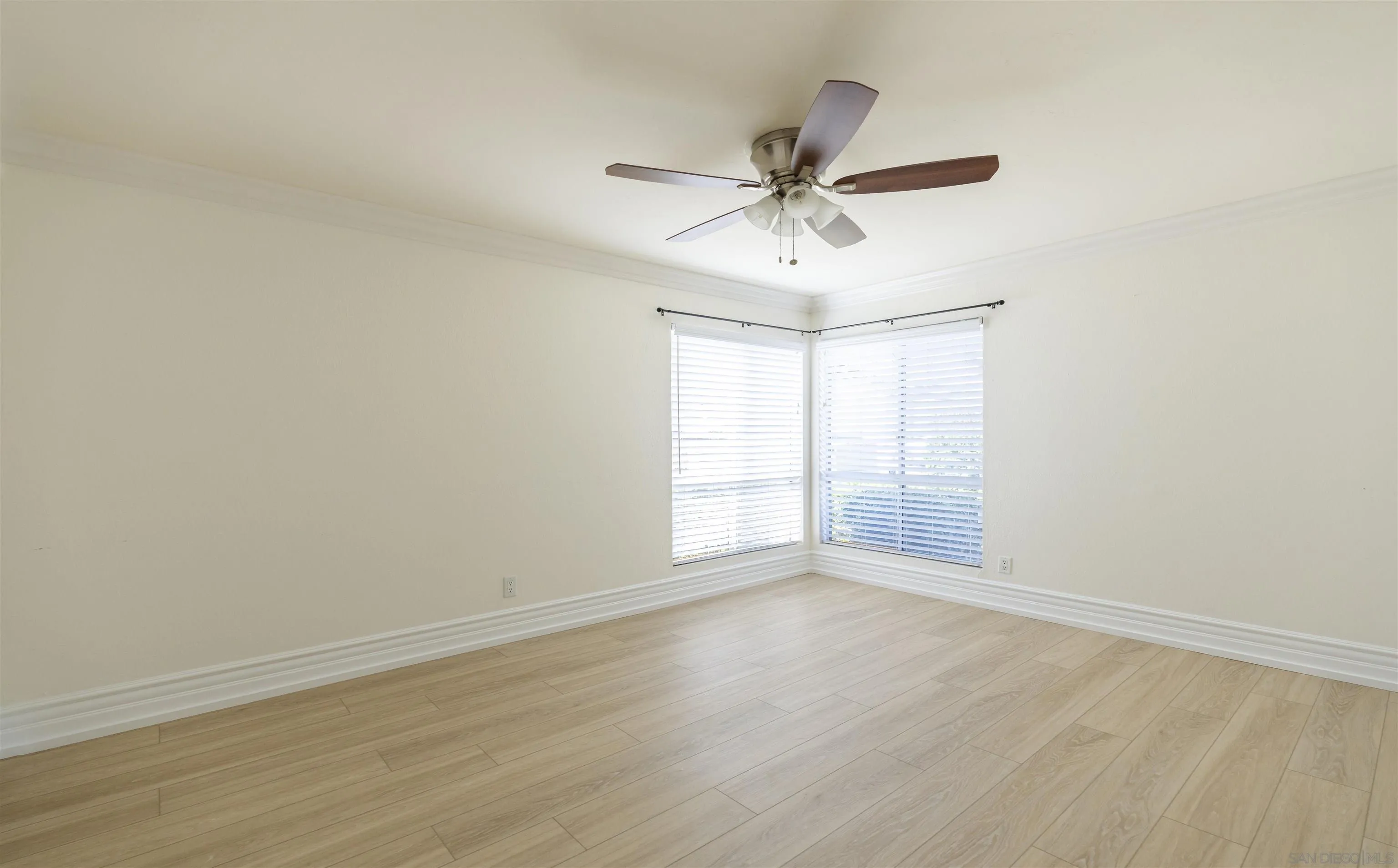 536 Telegraph Canyon Road, Unit E Chula Vista, CA 91910 - Photo 35 of 47 a view of an empty room with wooden floor and a window