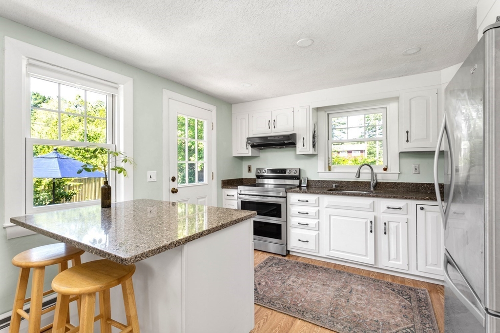 8 May Street Sharon, MA 02067 - Photo 12 of 39 a kitchen with granite countertop a stove a sink and a refrigerator