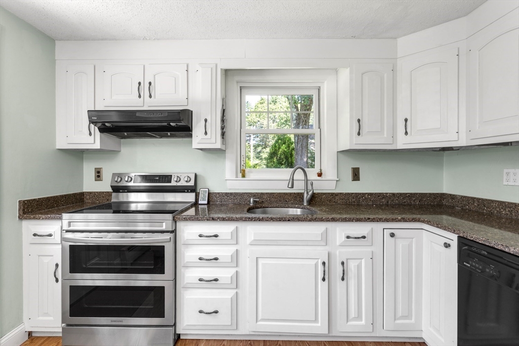 8 May Street Sharon, MA 02067 - Photo 13 of 39 a kitchen with granite countertop a stove and cabinets