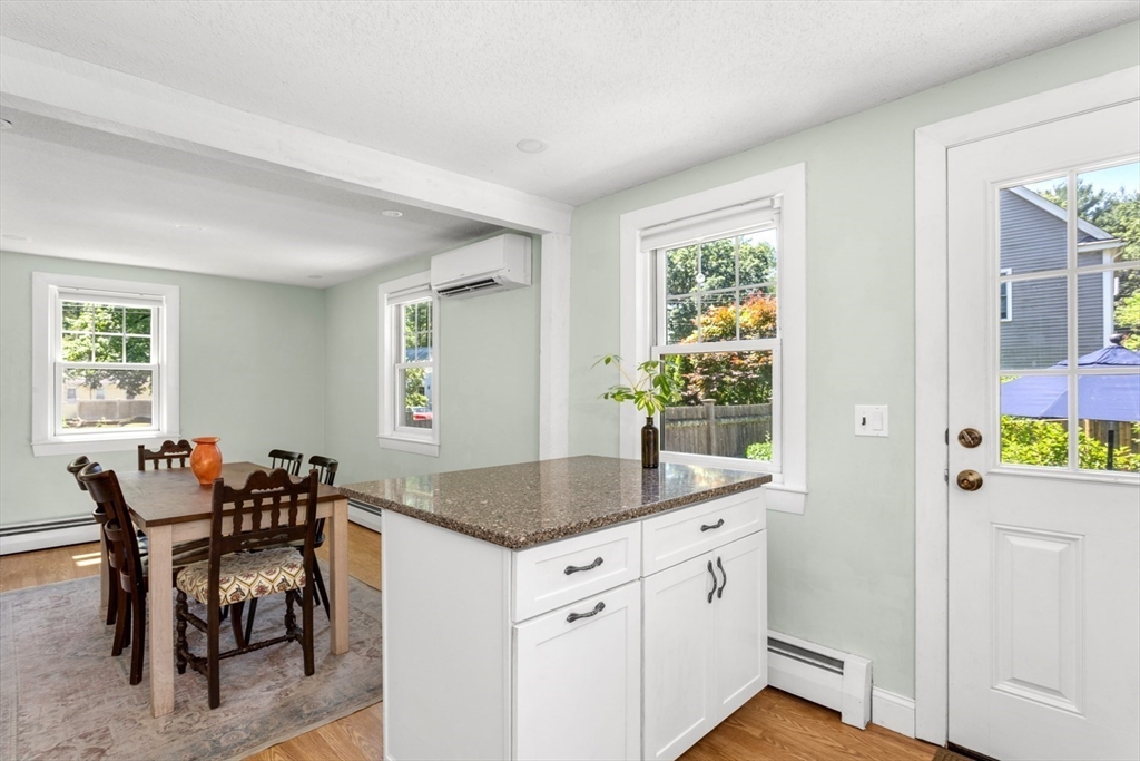 8 May Street Sharon, MA 02067 - Photo 14 of 39 a hall with kitchen island granite countertop a sink and a granite counter tops