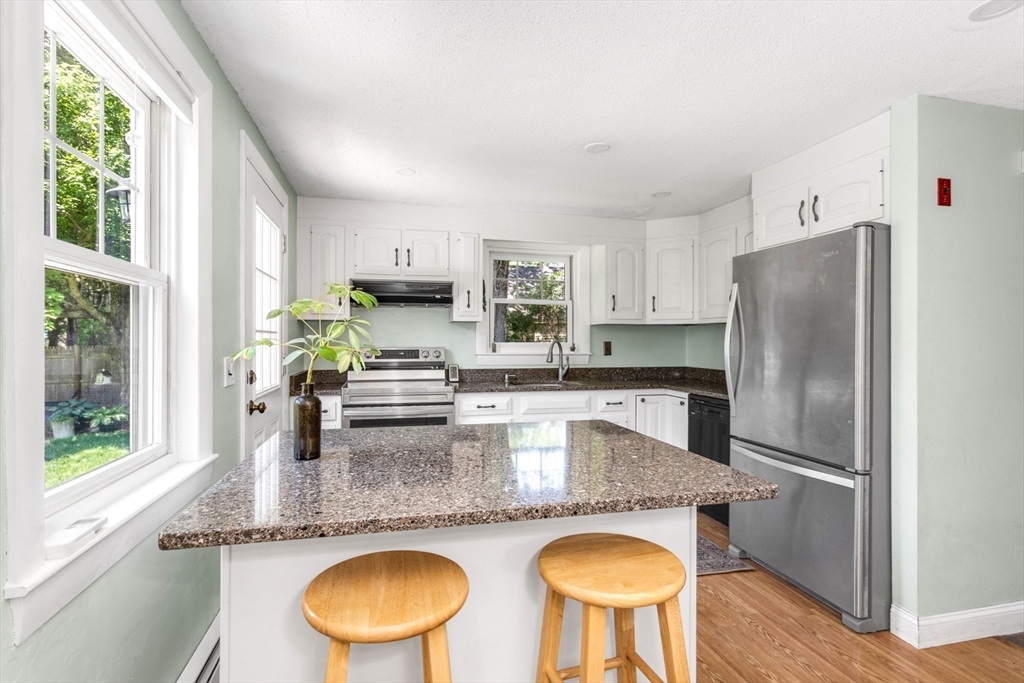 8 May Street Sharon, MA 02067 - Photo 15 of 39 a kitchen with stainless steel appliances granite countertop a sink a refrigerator and a stove