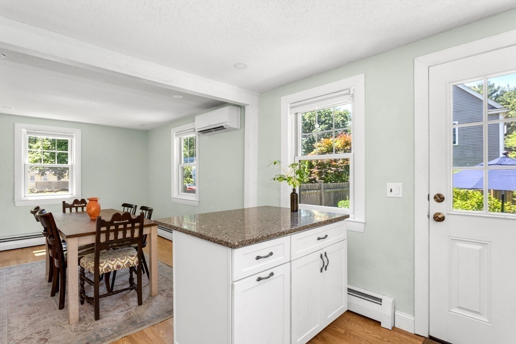 8 May Street Sharon, MA 02067 - Photo 17 of 39 a hall with kitchen island granite countertop furniture a window and a sink
