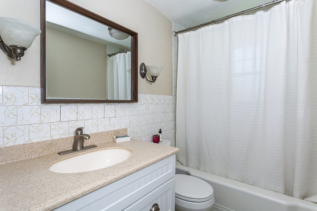 8 May Street Sharon, MA 02067 - Photo 18 of 39 a bathroom with a sink a toilet and a mirror