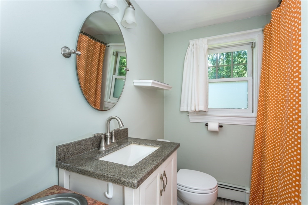 8 May Street Sharon, MA 02067 - Photo 22 of 39 a bathroom with a granite countertop toilet sink and mirror