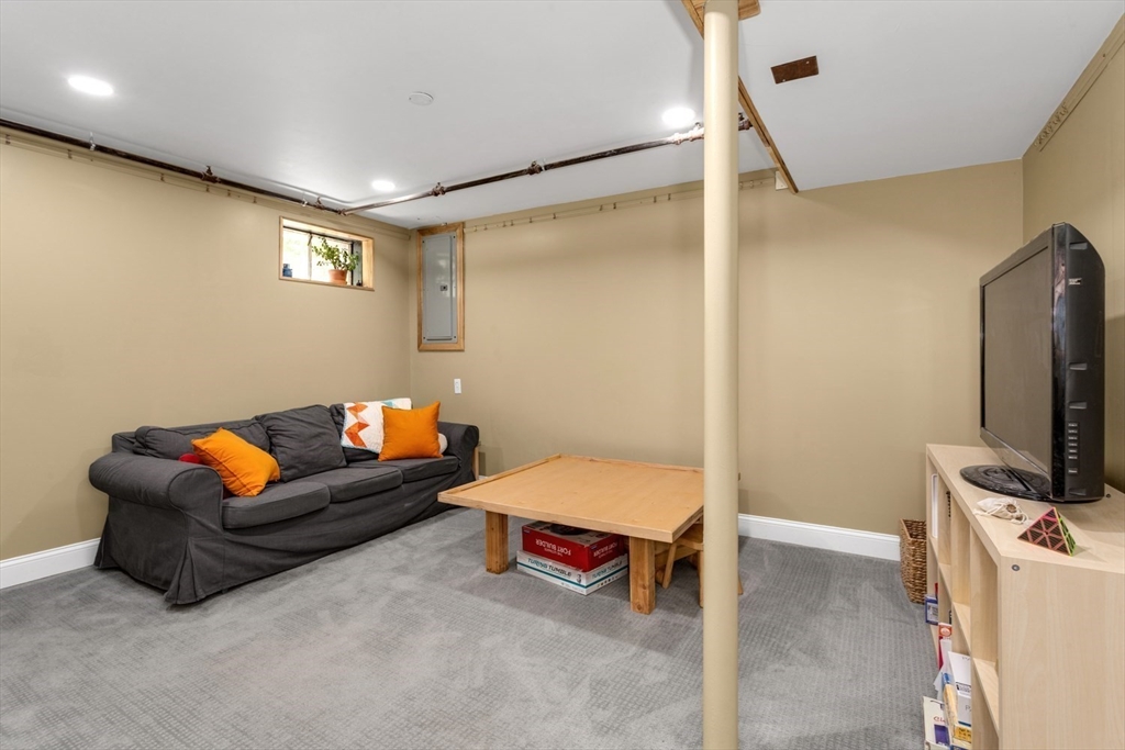 8 May Street Sharon, MA 02067 - Photo 28 of 39 a bedroom with furniture and a flat screen tv