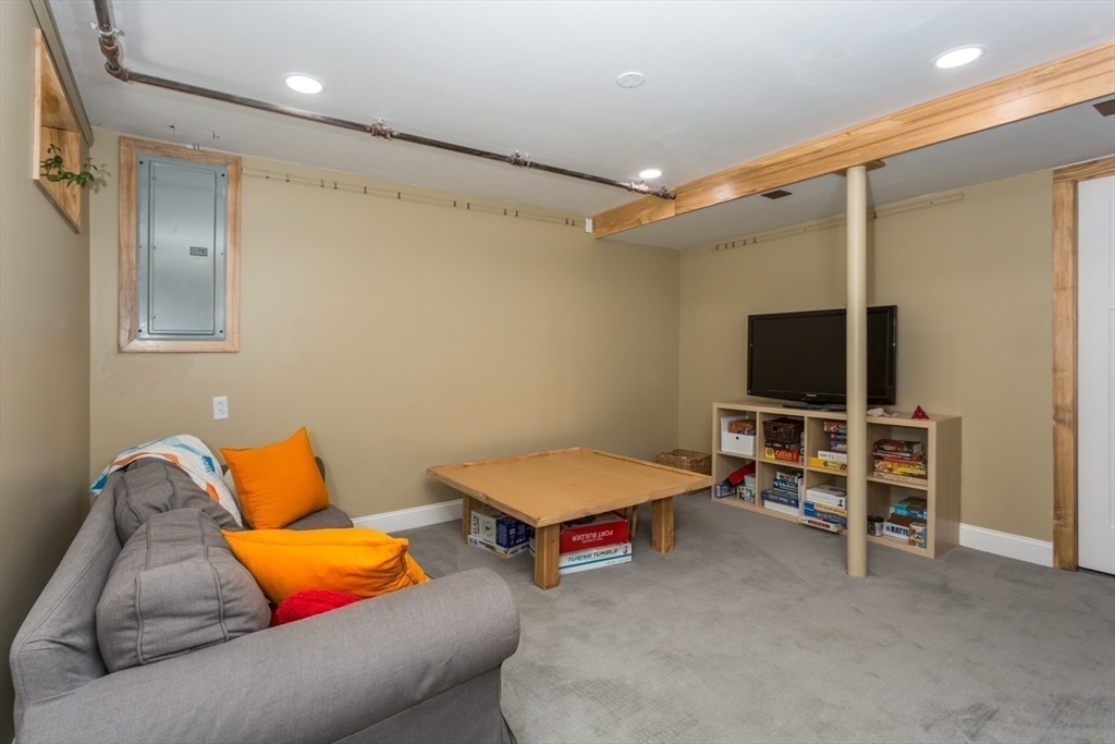 8 May Street Sharon, MA 02067 - Photo 29 of 39 a living room with furniture and a flat screen tv