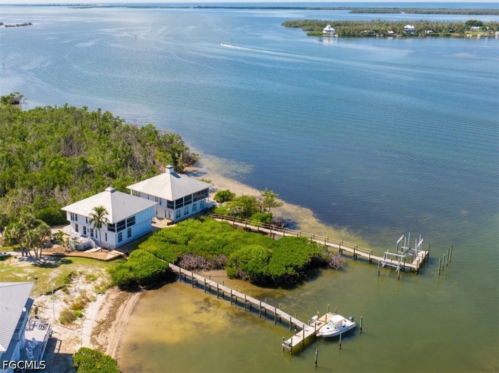 303 Useppa Useppa Island, Unit A Bokeelia, FL 33922 - Photo 1 of 50 an aerial view of a house with a lake view