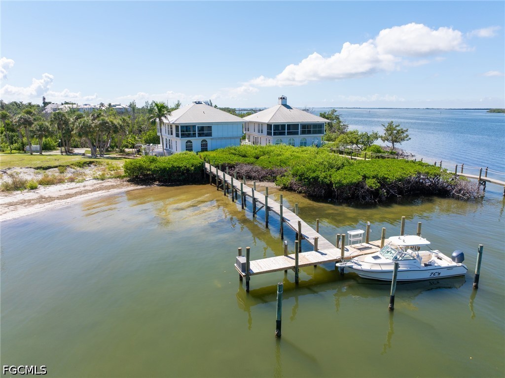 303 Useppa Useppa Island, Unit A Bokeelia, FL 33922 - Photo 12 of 50 an aerial view of a house with swimming pool patio and lake view