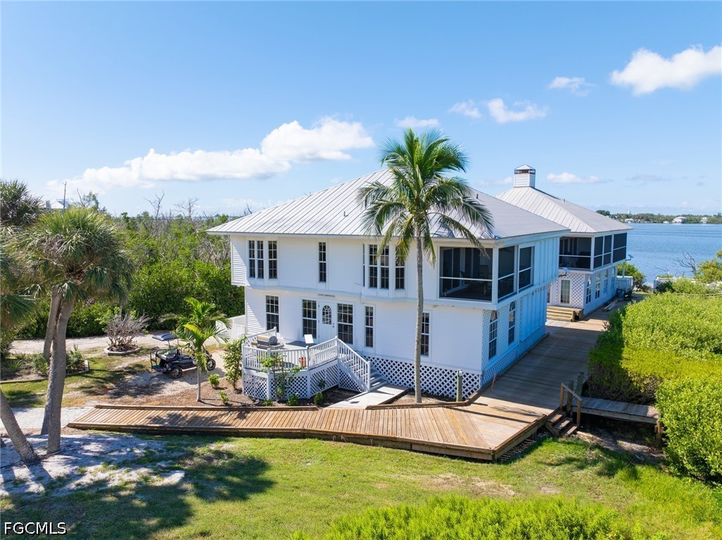 303 Useppa Useppa Island, Unit A Bokeelia, FL 33922 - Photo 14 of 50 a view of house with yard and swimming pool