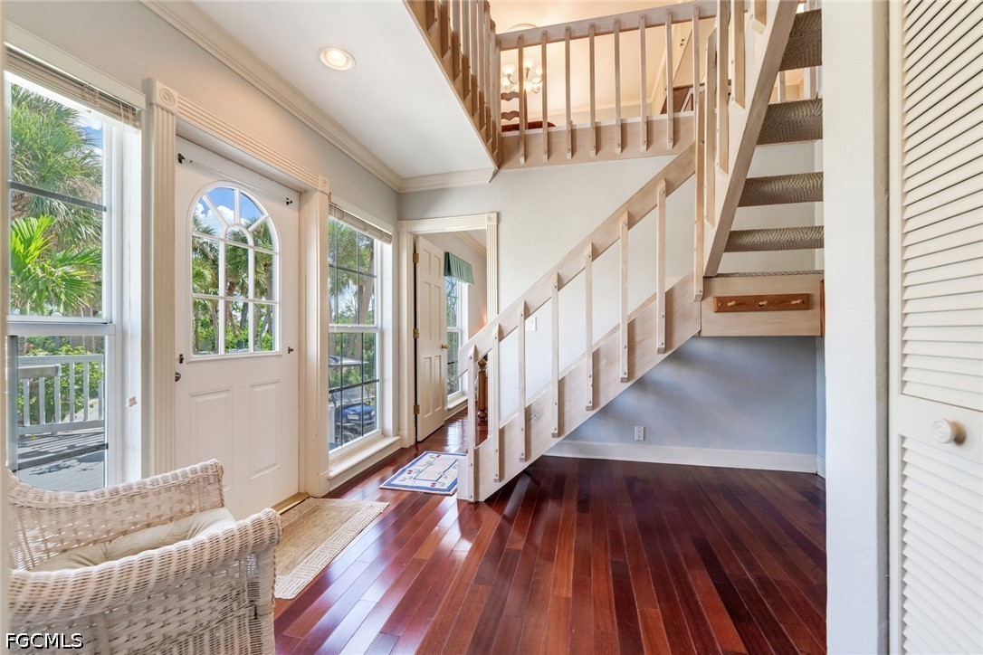 303 Useppa Useppa Island, Unit A Bokeelia, FL 33922 - Photo 15 of 50 a view of entryway with wooden floor and stairs