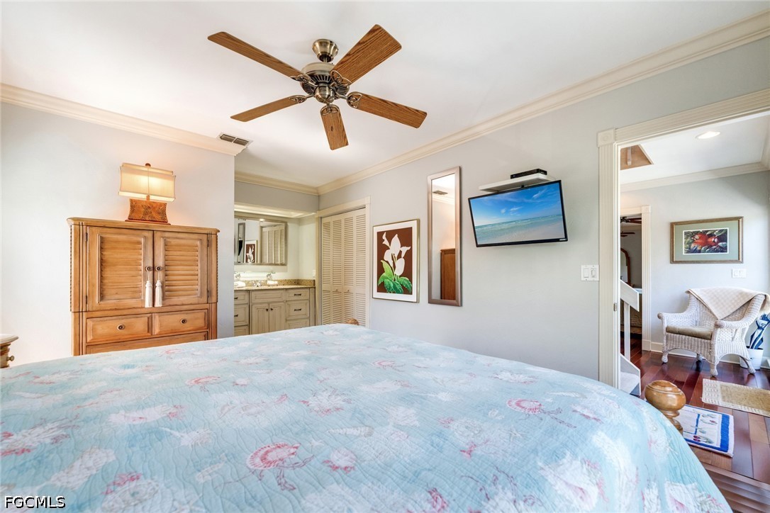 303 Useppa Useppa Island, Unit A Bokeelia, FL 33922 - Photo 17 of 50 a bedroom with a large bed a flat tv screen and dresser
