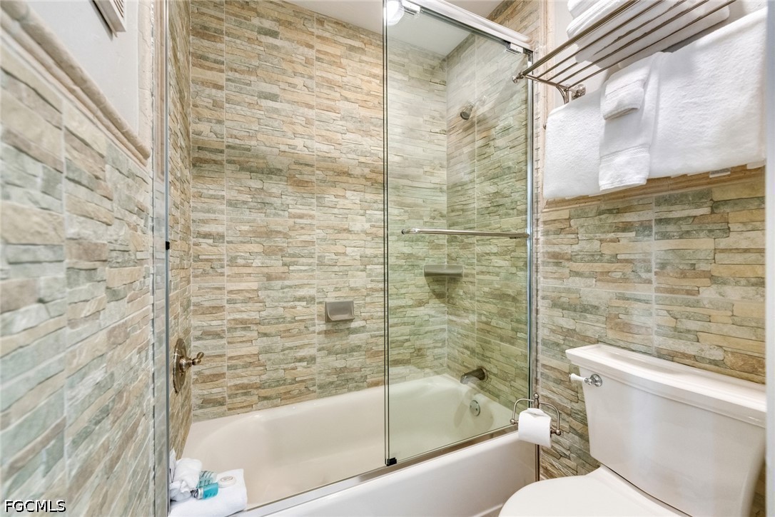 303 Useppa Useppa Island, Unit A Bokeelia, FL 33922 - Photo 19 of 50 a bathroom with a bathtub and a shower