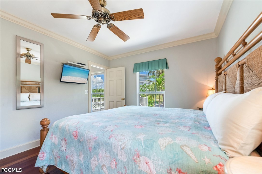 303 Useppa Useppa Island, Unit A Bokeelia, FL 33922 - Photo 21 of 50 a bedroom with a large bed and a window