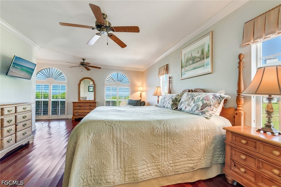 303 Useppa Useppa Island, Unit A Bokeelia, FL 33922 - Photo 23 of 50 a bedroom with a large bed and a chandelier