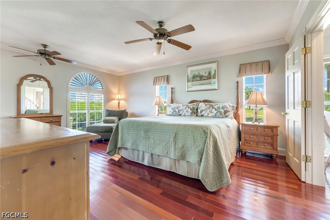 303 Useppa Useppa Island, Unit A Bokeelia, FL 33922 - Photo 24 of 50 a bedroom with a bed window and a table