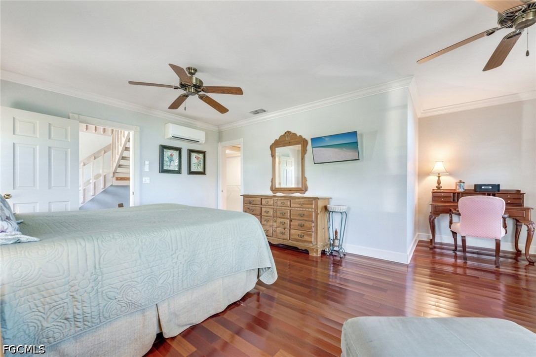 303 Useppa Useppa Island, Unit A Bokeelia, FL 33922 - Photo 25 of 50 a bedroom with furniture and wooden floor