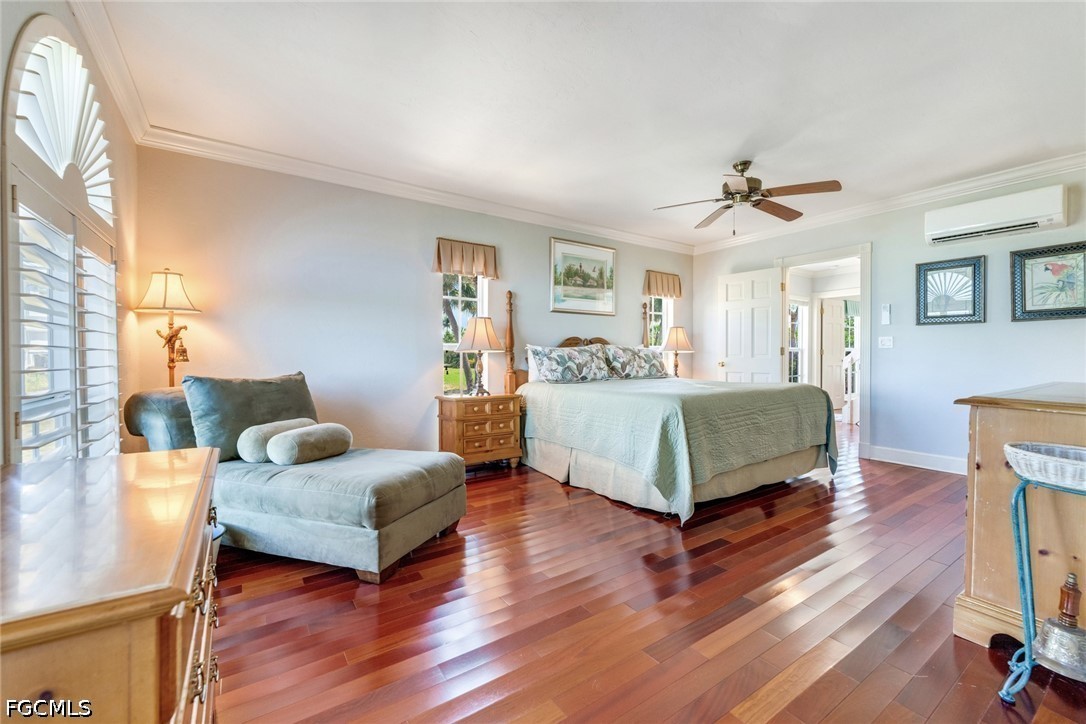 303 Useppa Useppa Island, Unit A Bokeelia, FL 33922 - Photo 29 of 50 a bedroom with a bed wooden floor and a table