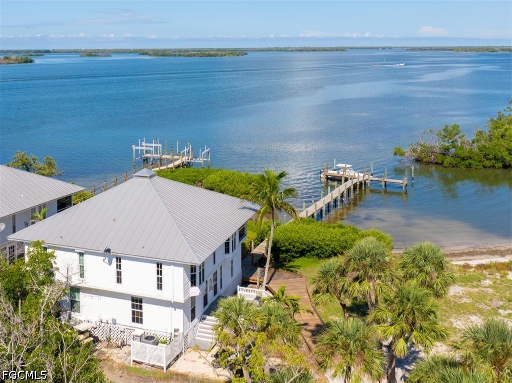 303 Useppa Useppa Island, Unit A Bokeelia, FL 33922 - Photo 3 of 50 a aerial view of a house with a yard and lake view