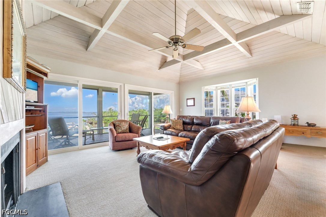 303 Useppa Useppa Island, Unit A Bokeelia, FL 33922 - Photo 32 of 50 a living room with furniture and a fireplace