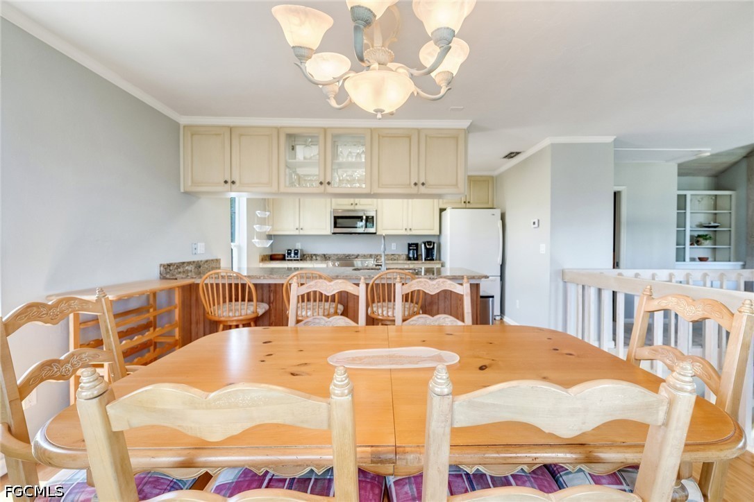 303 Useppa Useppa Island, Unit A Bokeelia, FL 33922 - Photo 43 of 50 a large kitchen with a table chairs and a view of kitchen