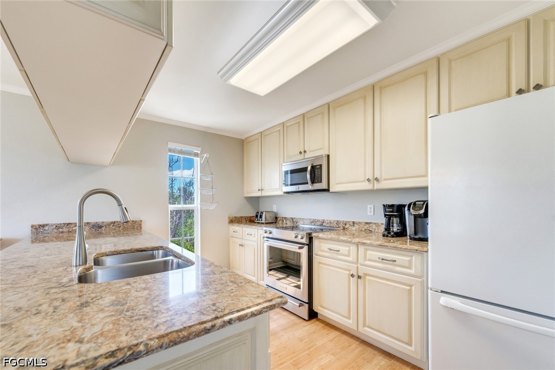 303 Useppa Useppa Island, Unit A Bokeelia, FL 33922 - Photo 46 of 50 a kitchen with stainless steel appliances granite countertop a stove a sink dishwasher and a refrigerator
