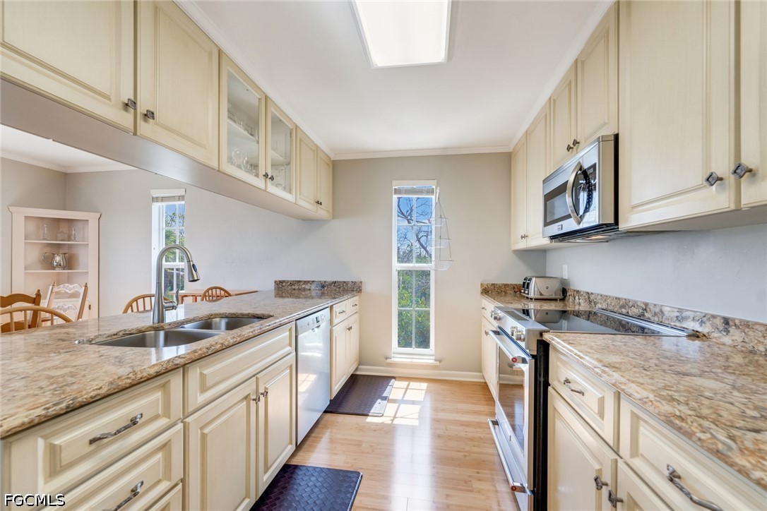 303 Useppa Useppa Island, Unit A Bokeelia, FL 33922 - Photo 47 of 50 a kitchen with stainless steel appliances granite countertop a stove and a sink