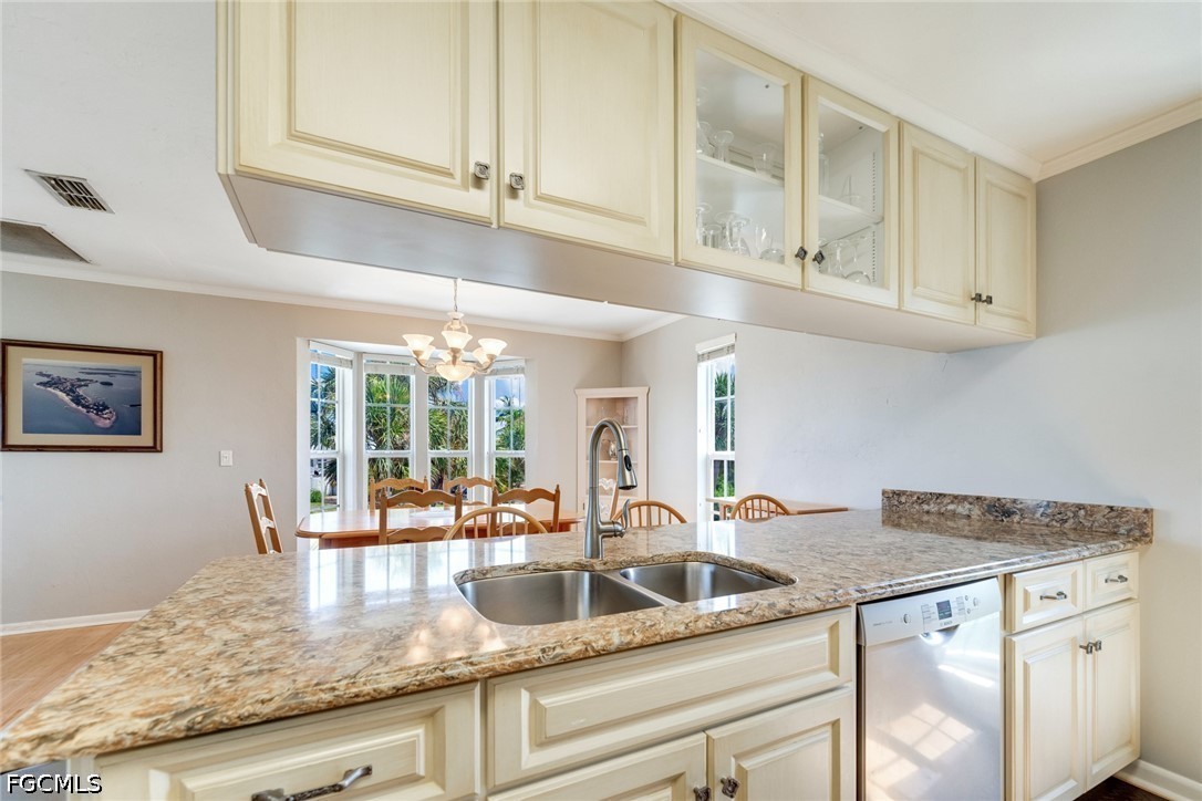 303 Useppa Useppa Island, Unit A Bokeelia, FL 33922 - Photo 48 of 50 a kitchen with granite countertop a sink and cabinets