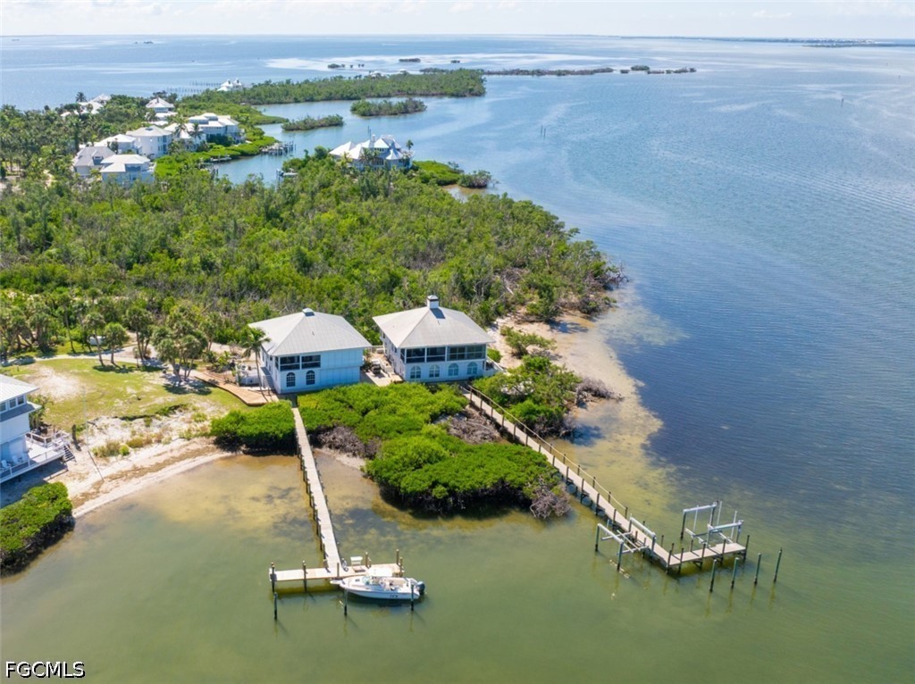 303 Useppa Useppa Island, Unit A Bokeelia, FL 33922 - Photo 5 of 50 an aerial view of a house with yard swimming pool and outdoor seating