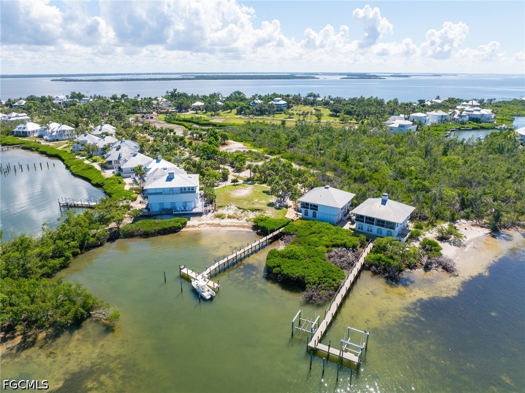 303 Useppa Useppa Island, Unit A Bokeelia, FL 33922 - Photo 6 of 50 an aerial view of a house with a yard and lake view