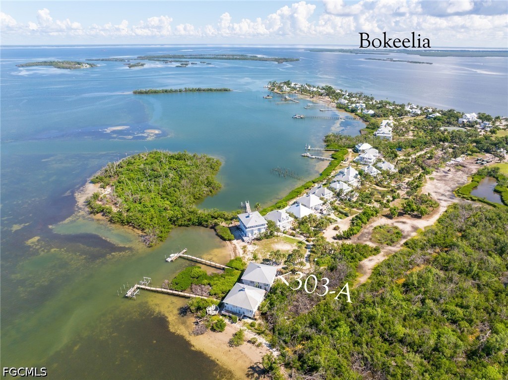 303 Useppa Useppa Island, Unit A Bokeelia, FL 33922 - Photo 9 of 50 an aerial view of a house with a yard
